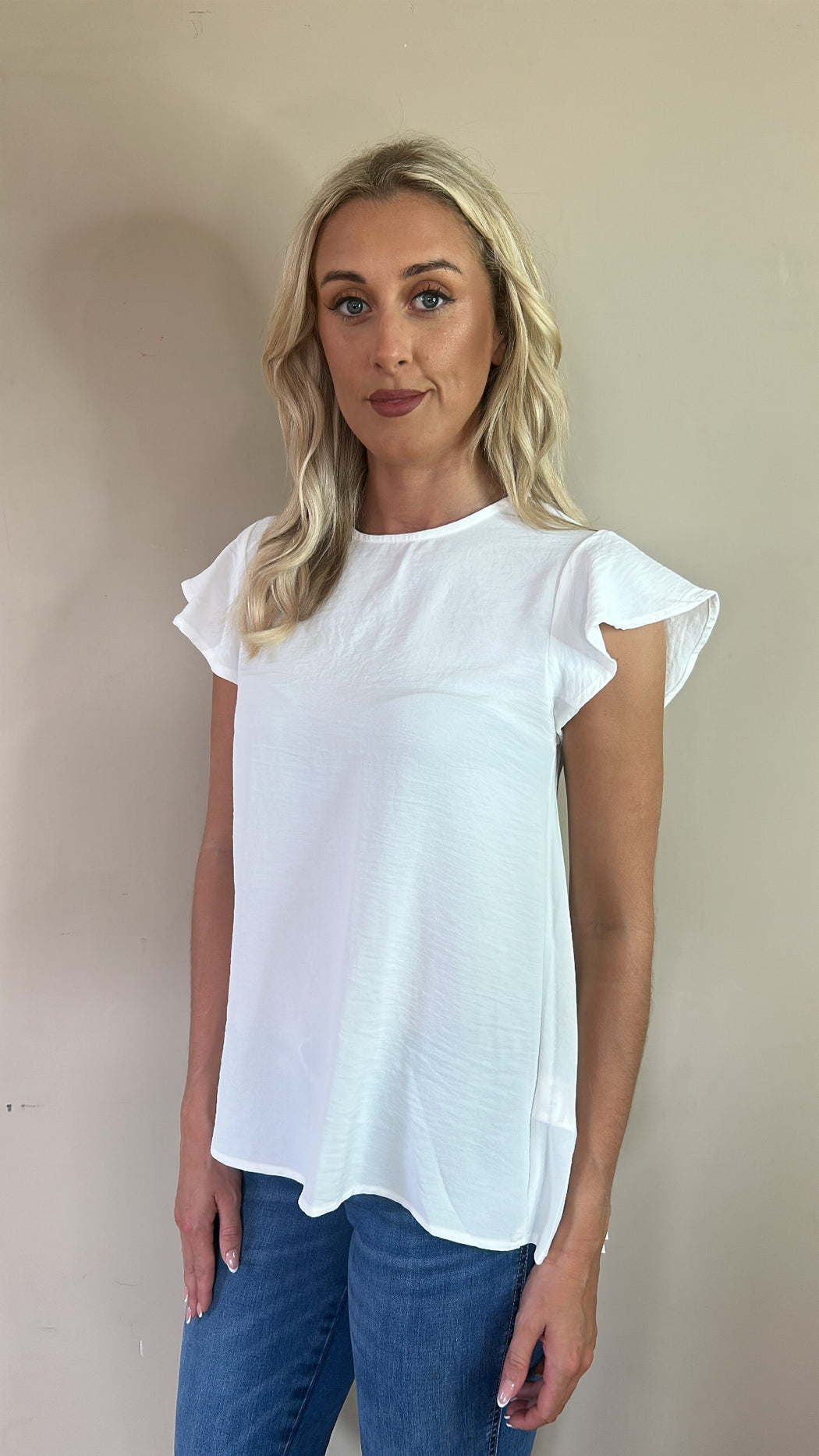 Kara ivory white dipped hem pleated back top