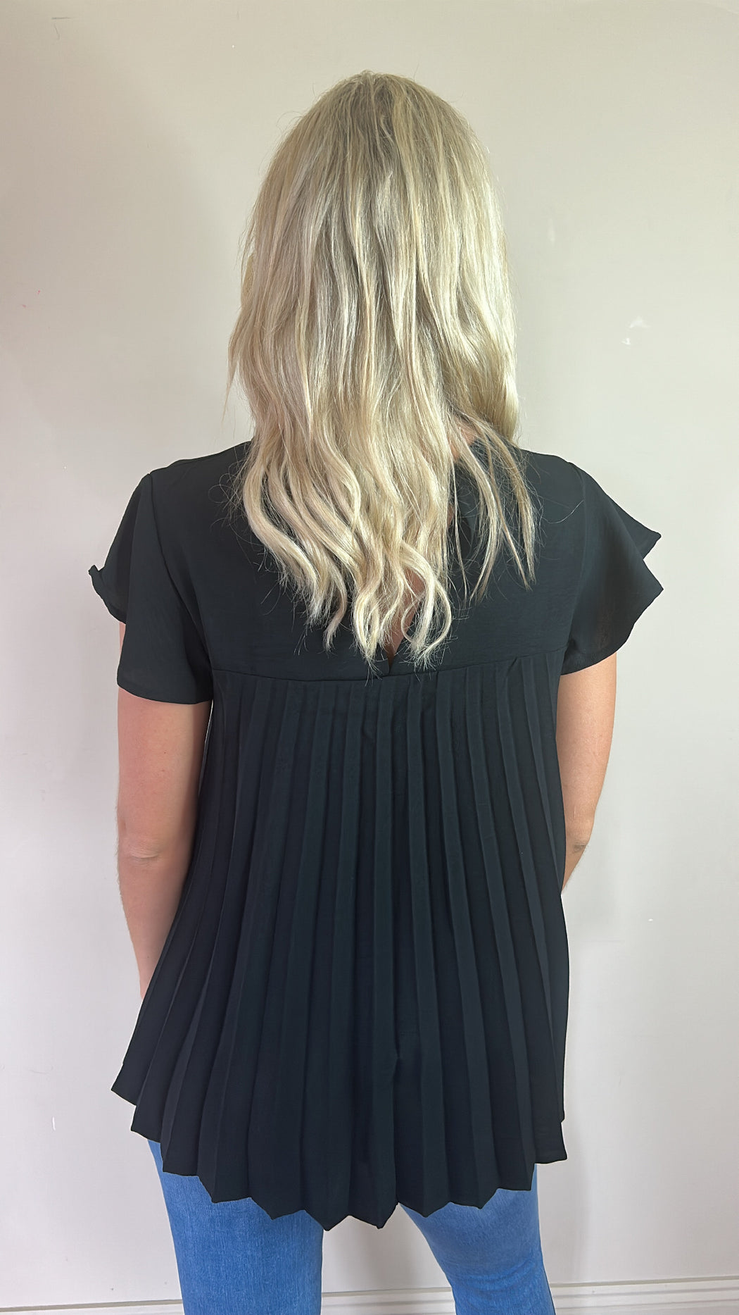 Kara black dipped hem pleated back top